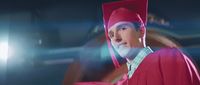 a man in a red graduation cap and gown