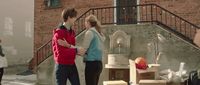 a group of people standing around a fountain