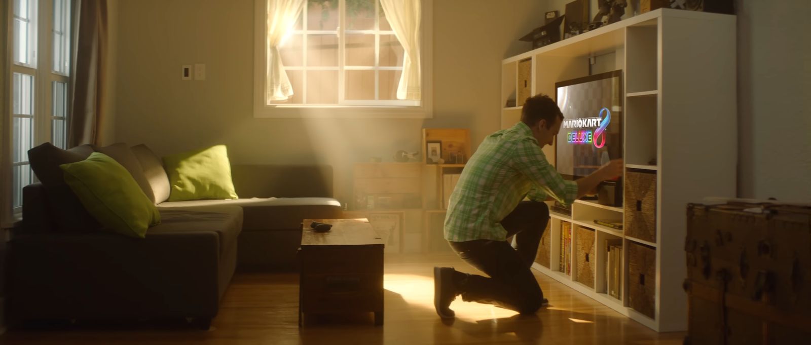 a man standing in a living room next to a window