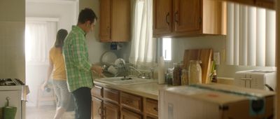 a man and a woman standing in a kitchen