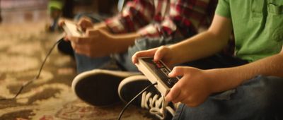 two people sitting on the floor playing a video game