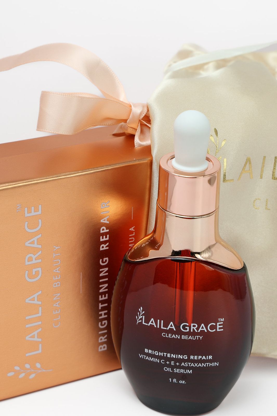a bottle of perfume next to a gold box