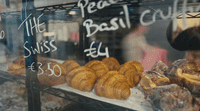 a bakery window with pastries and pastries on display