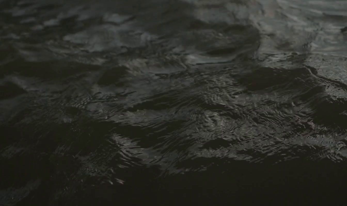 a close up of a black surface of water