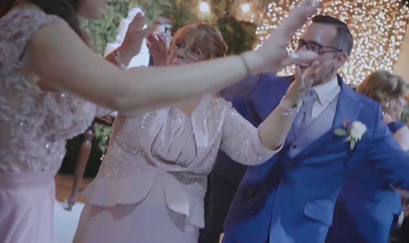 a man and woman are dancing together at a wedding