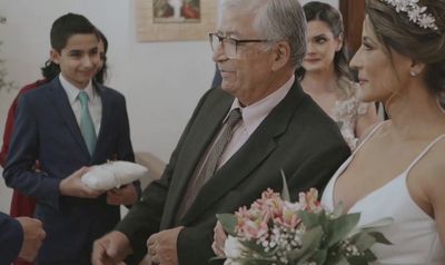 a man in a suit standing next to a woman in a wedding dress