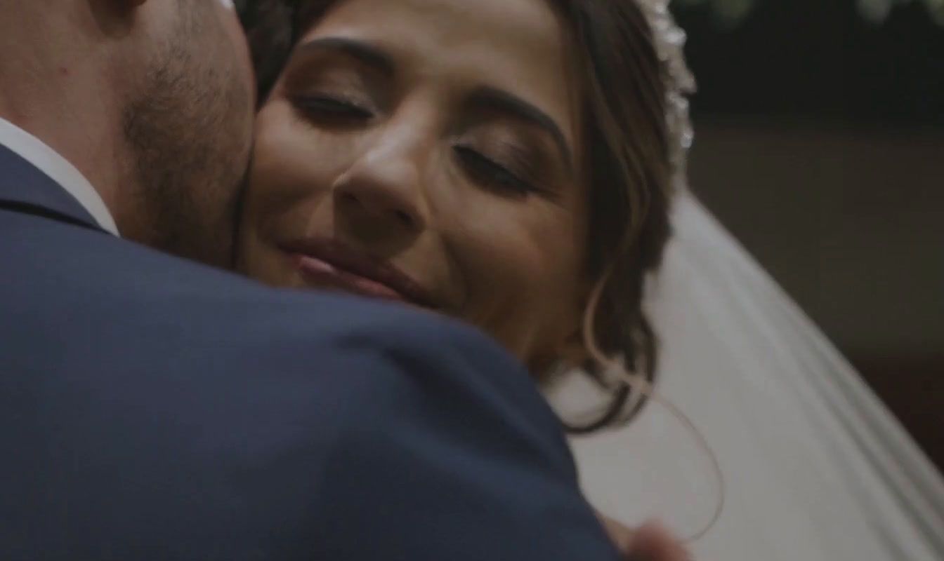 a bride and groom embracing each other