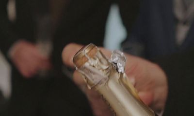 a close up of a person holding a champagne bottle