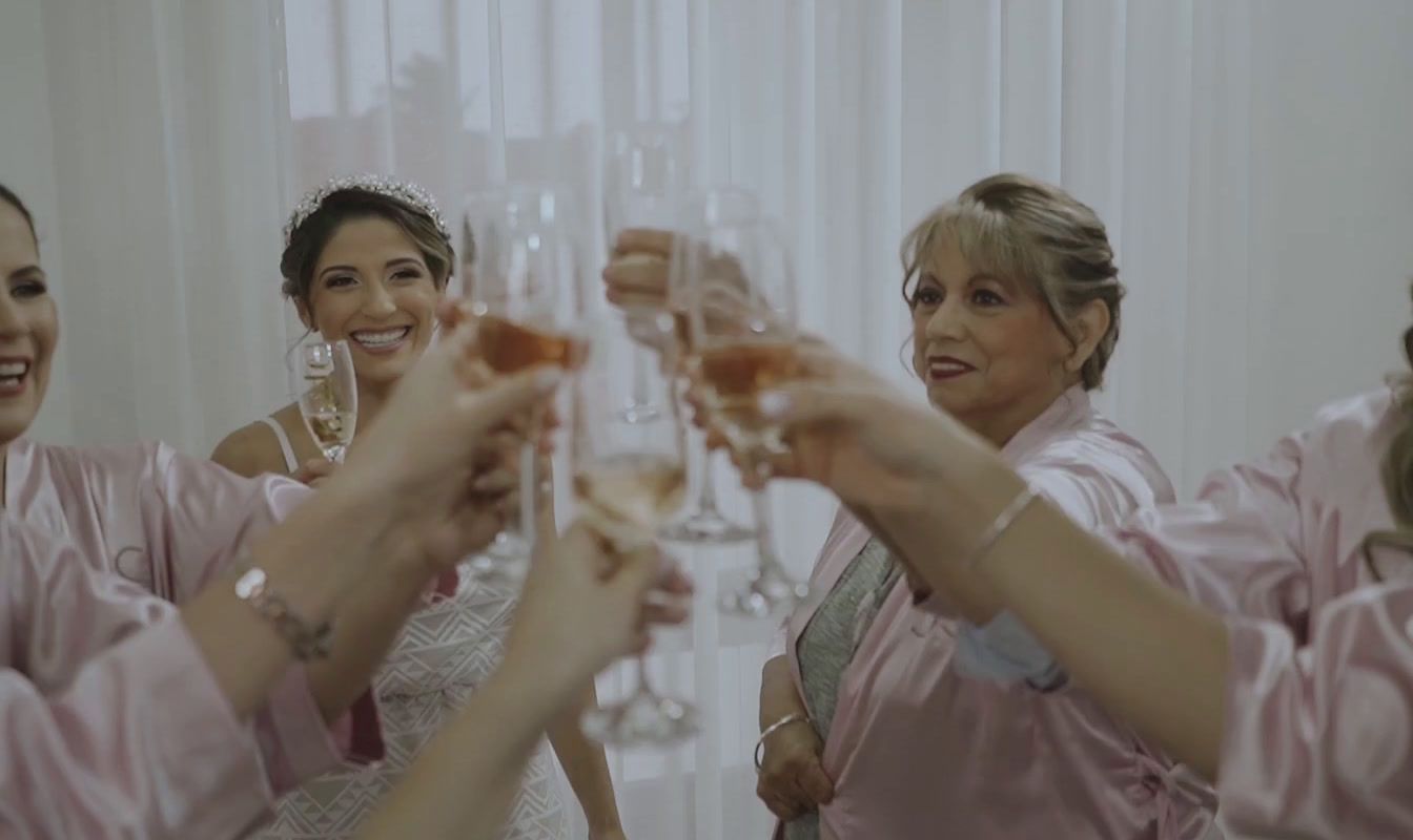 a group of bridesmaids toasting with champagne