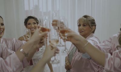 a group of bridesmaids toasting with champagne