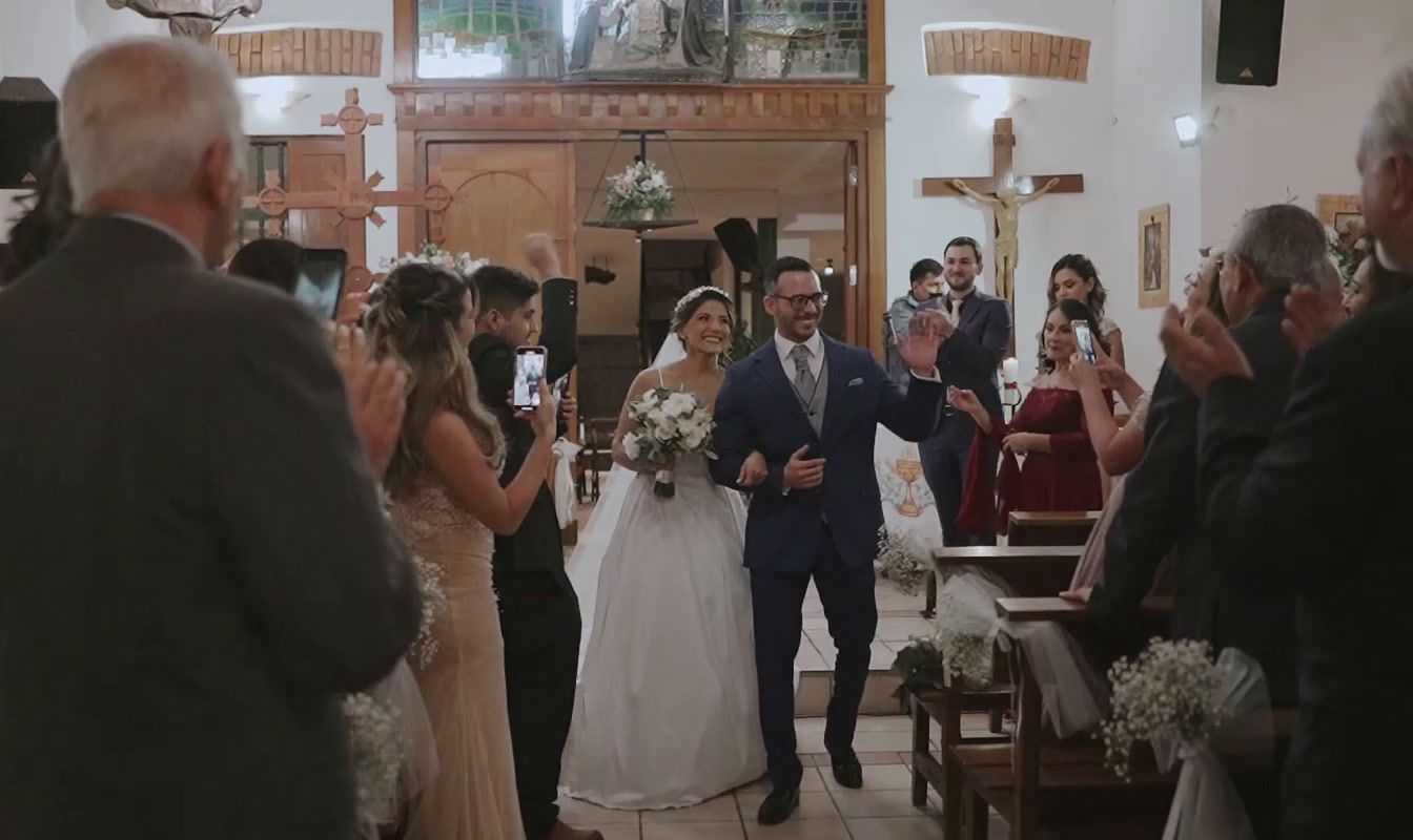 a bride and groom walking down the aisle of a church