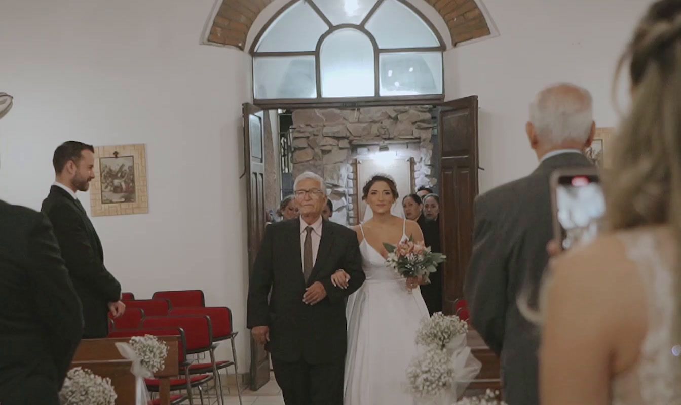 a bride and groom walking down the aisle of a church