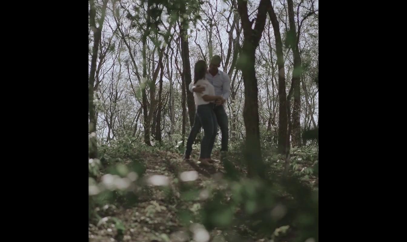 a couple of people standing in the woods