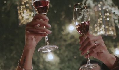 a group of people toasting with wine glasses