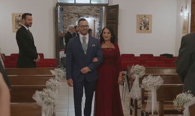 a man and a woman walking down a church aisle