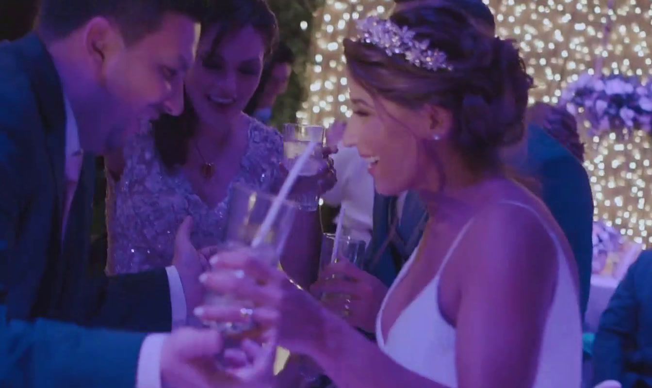 a bride and groom toasting at a wedding reception