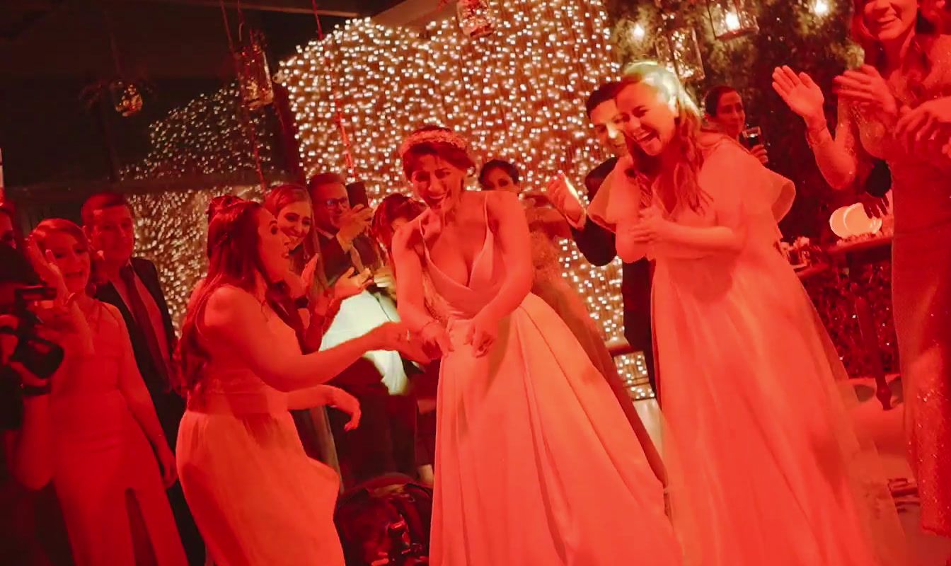 a group of people standing around in front of a christmas tree