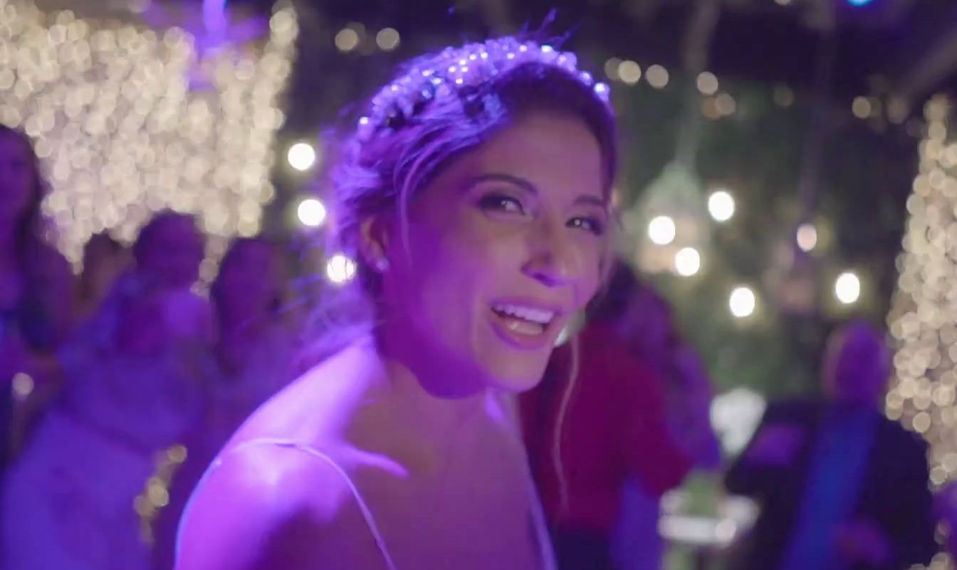 a woman wearing a tiara standing in front of a crowd