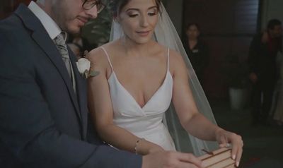 a bride and groom cutting their wedding cake