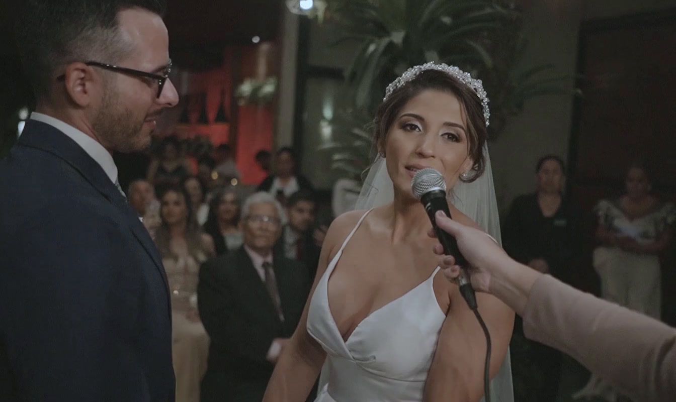 a woman in a wedding dress holding a microphone