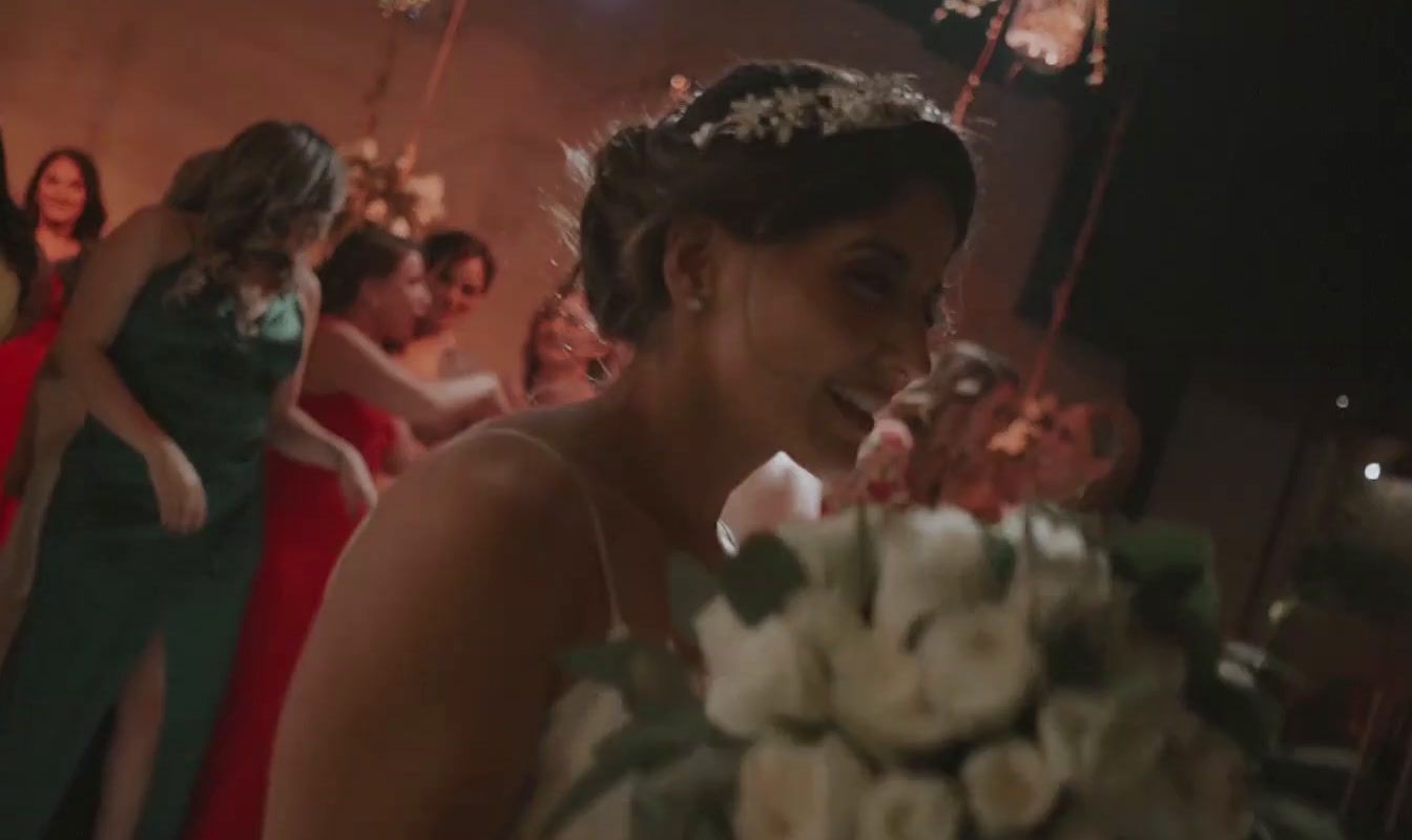 a woman in a red dress standing next to a bouquet of flowers