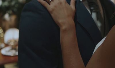 a close up of a person holding a woman's hand