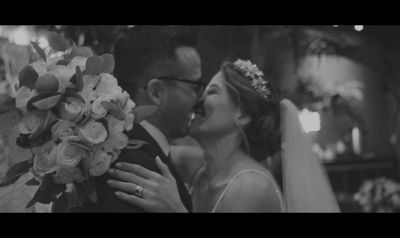 a bride and groom kissing in a black and white photo