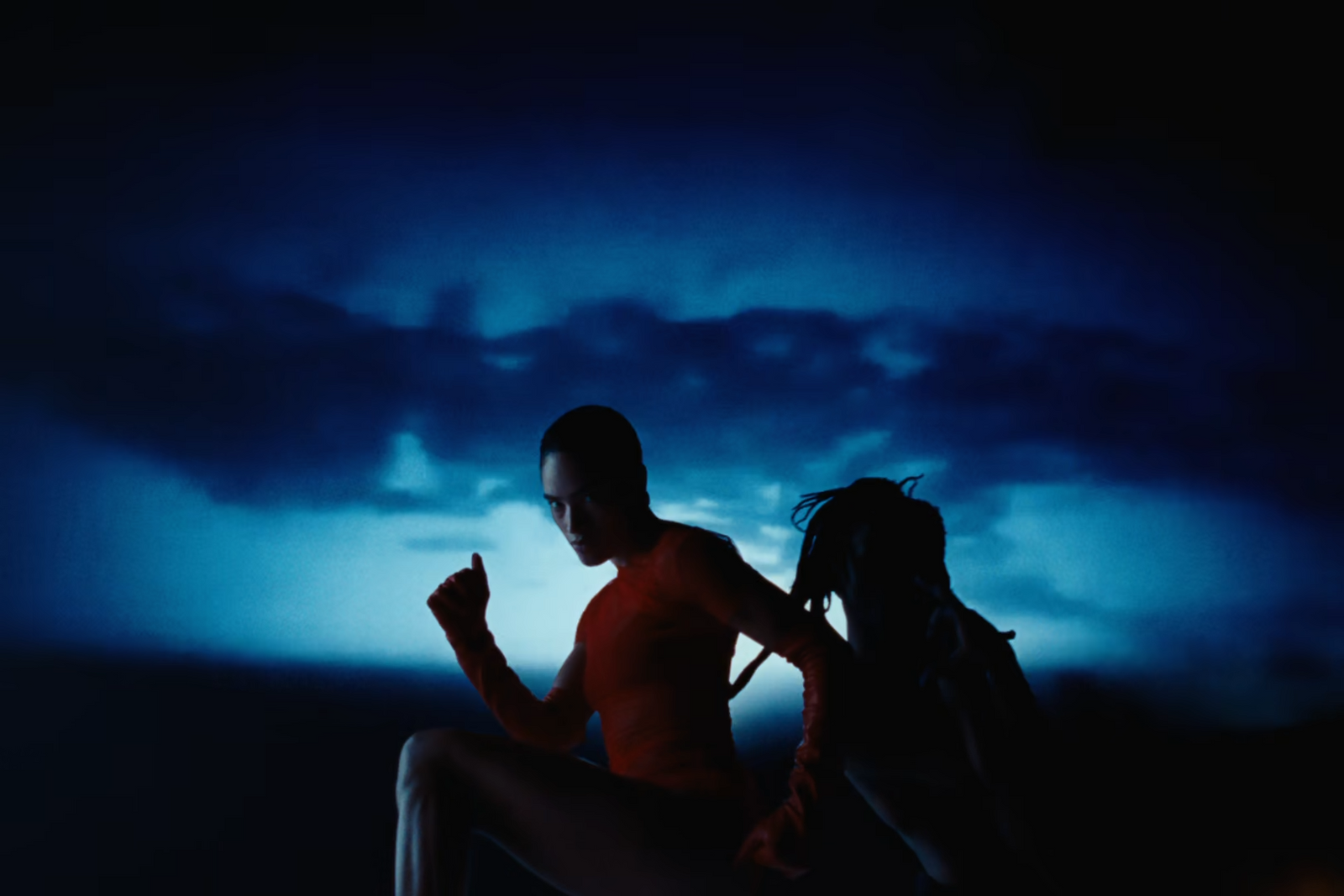 a man and a woman sitting in the dark