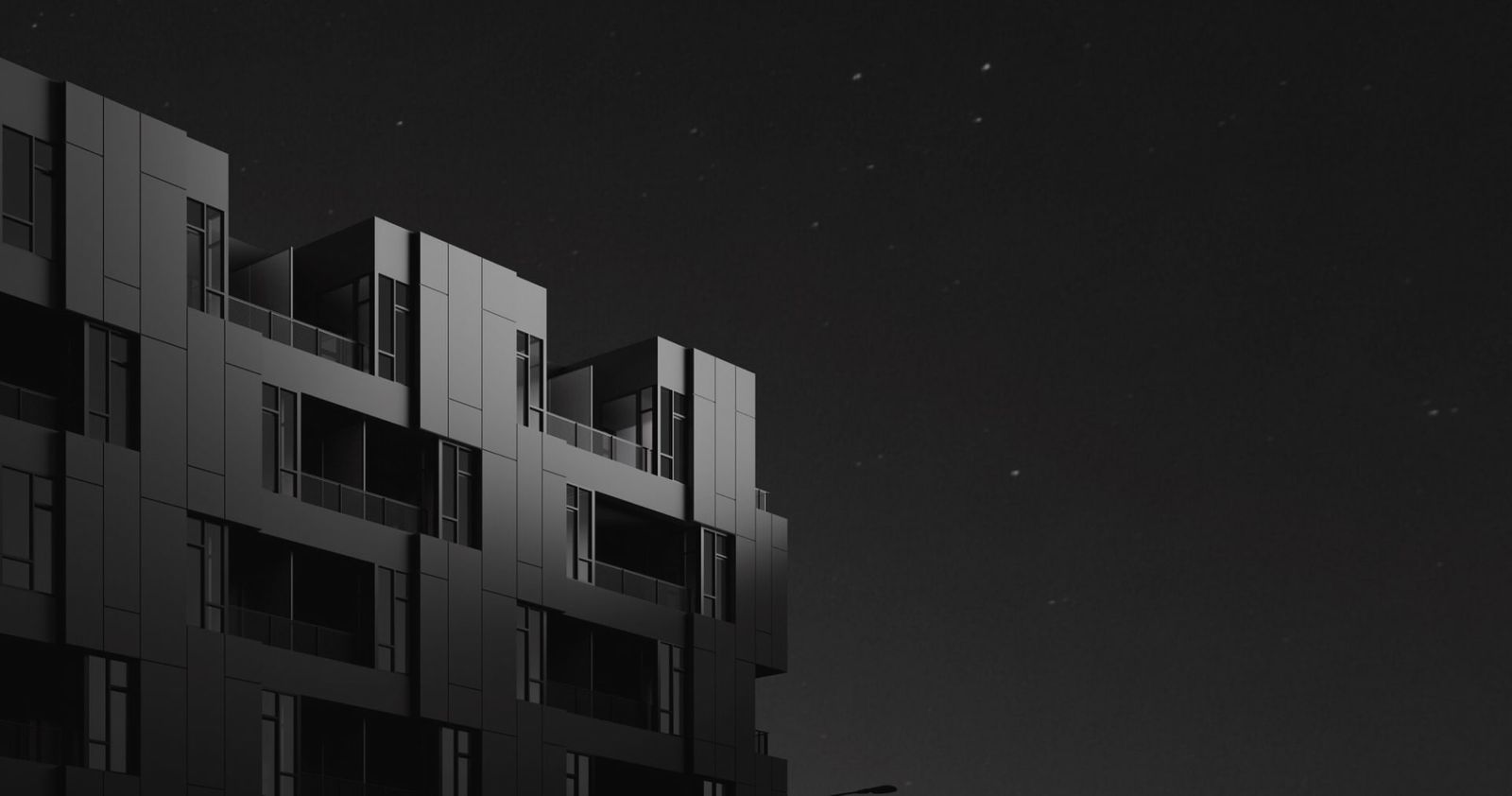 a black and white photo of a building at night