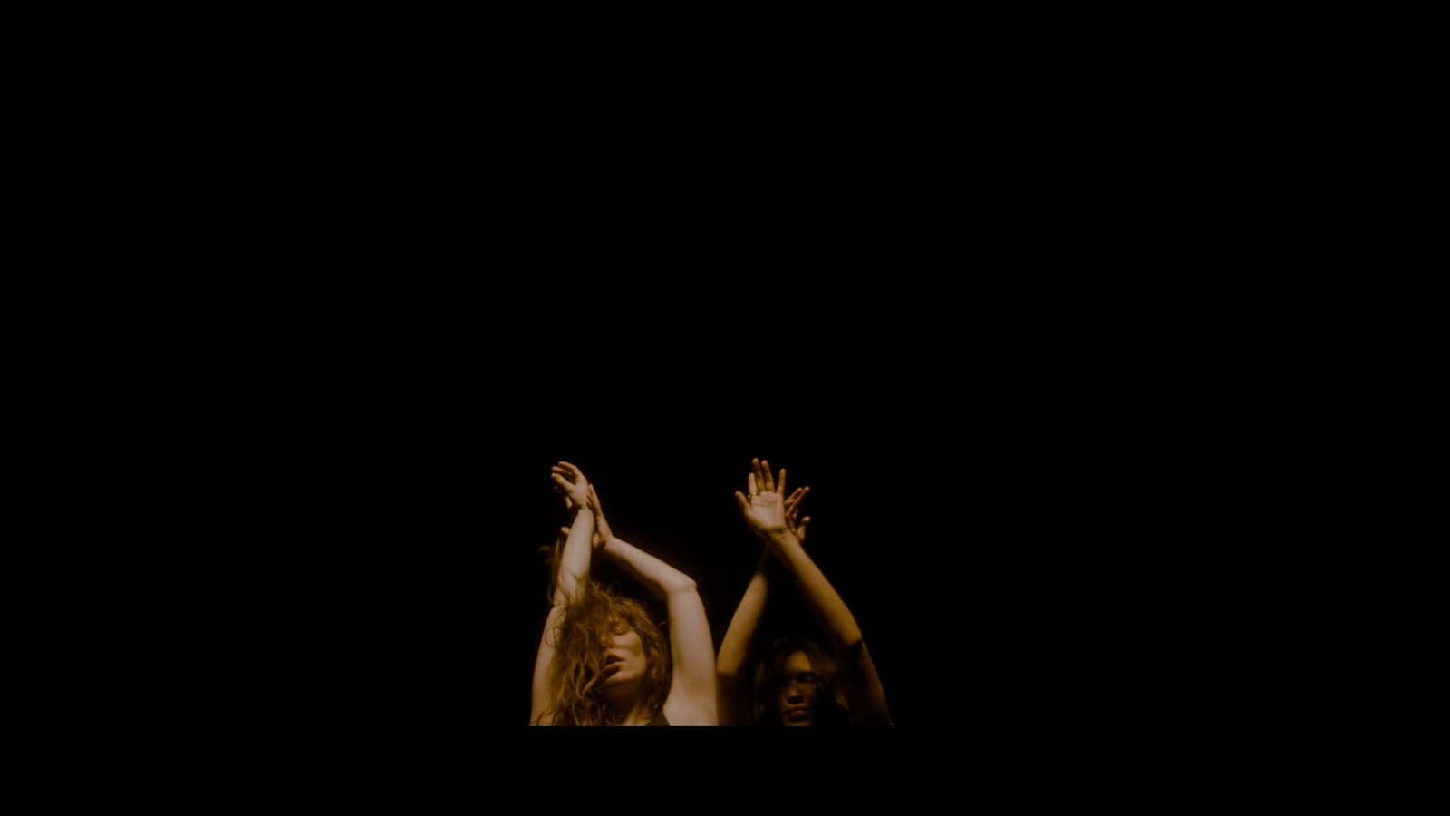 two women reaching up in the air with their hands