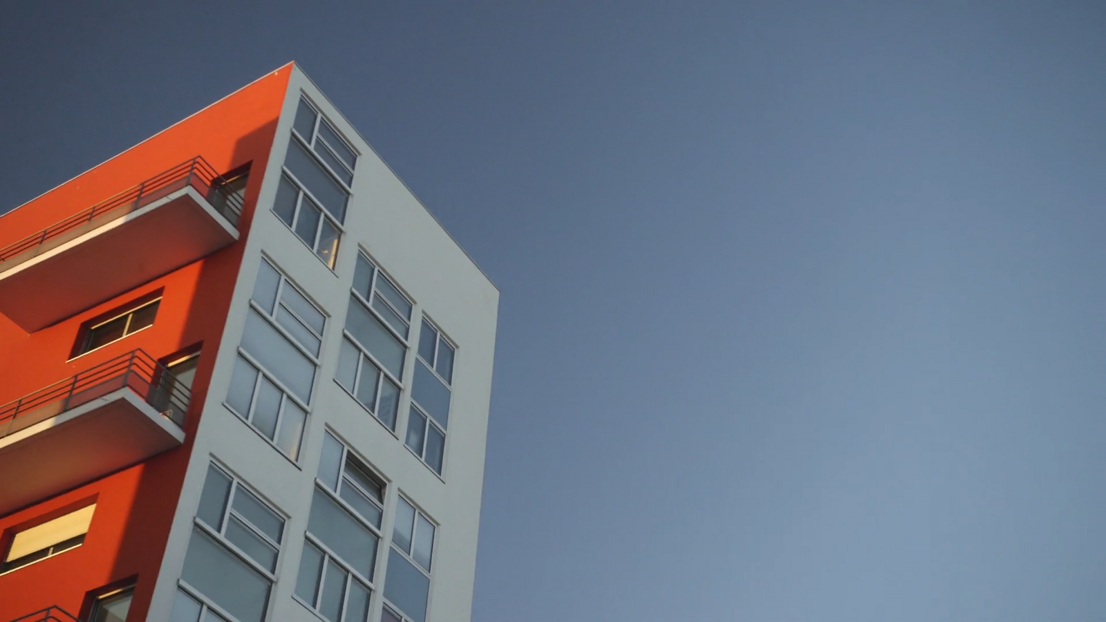 a tall building with balconies on the top of it