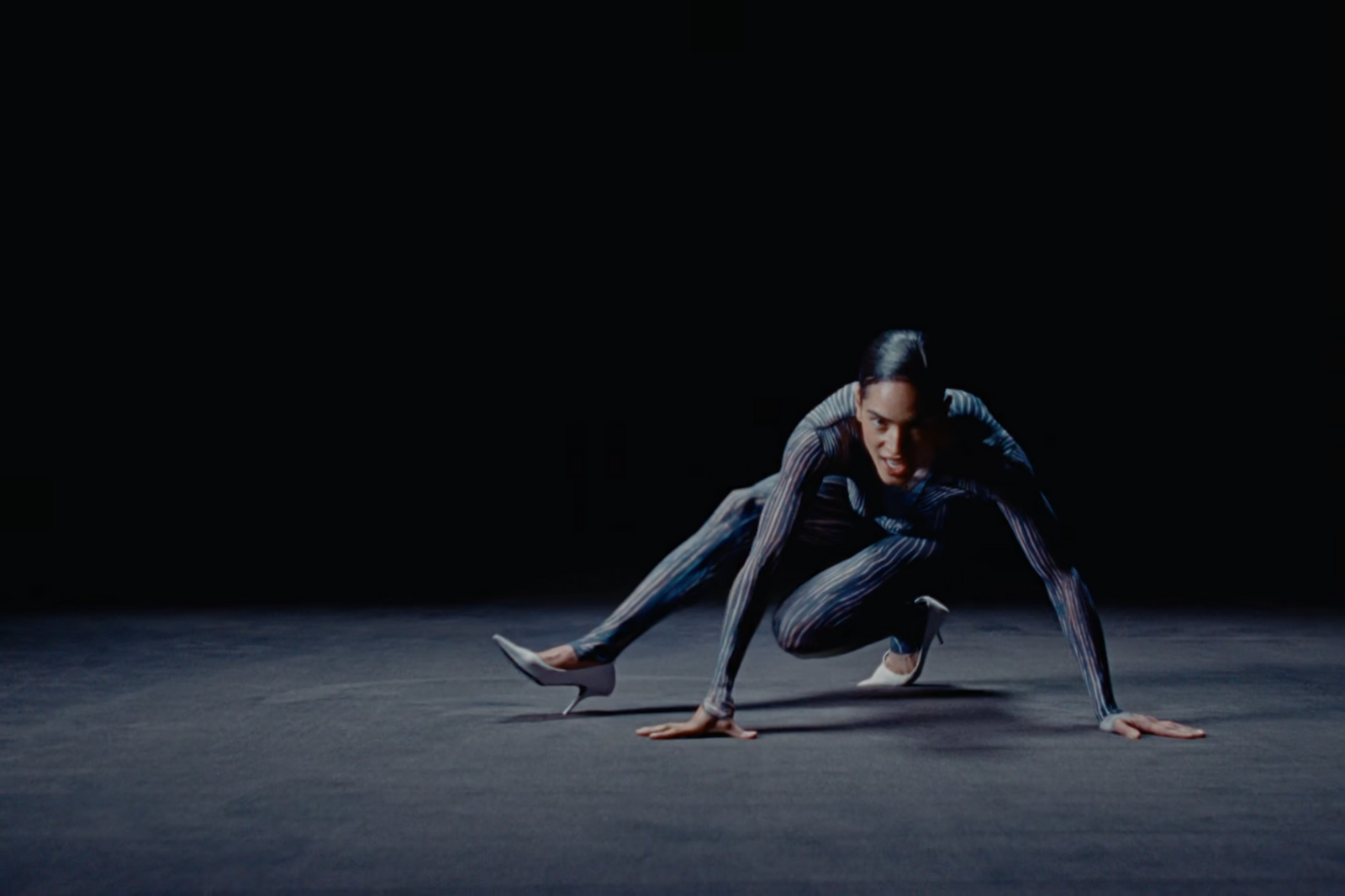 a man is doing a handstand in the dark