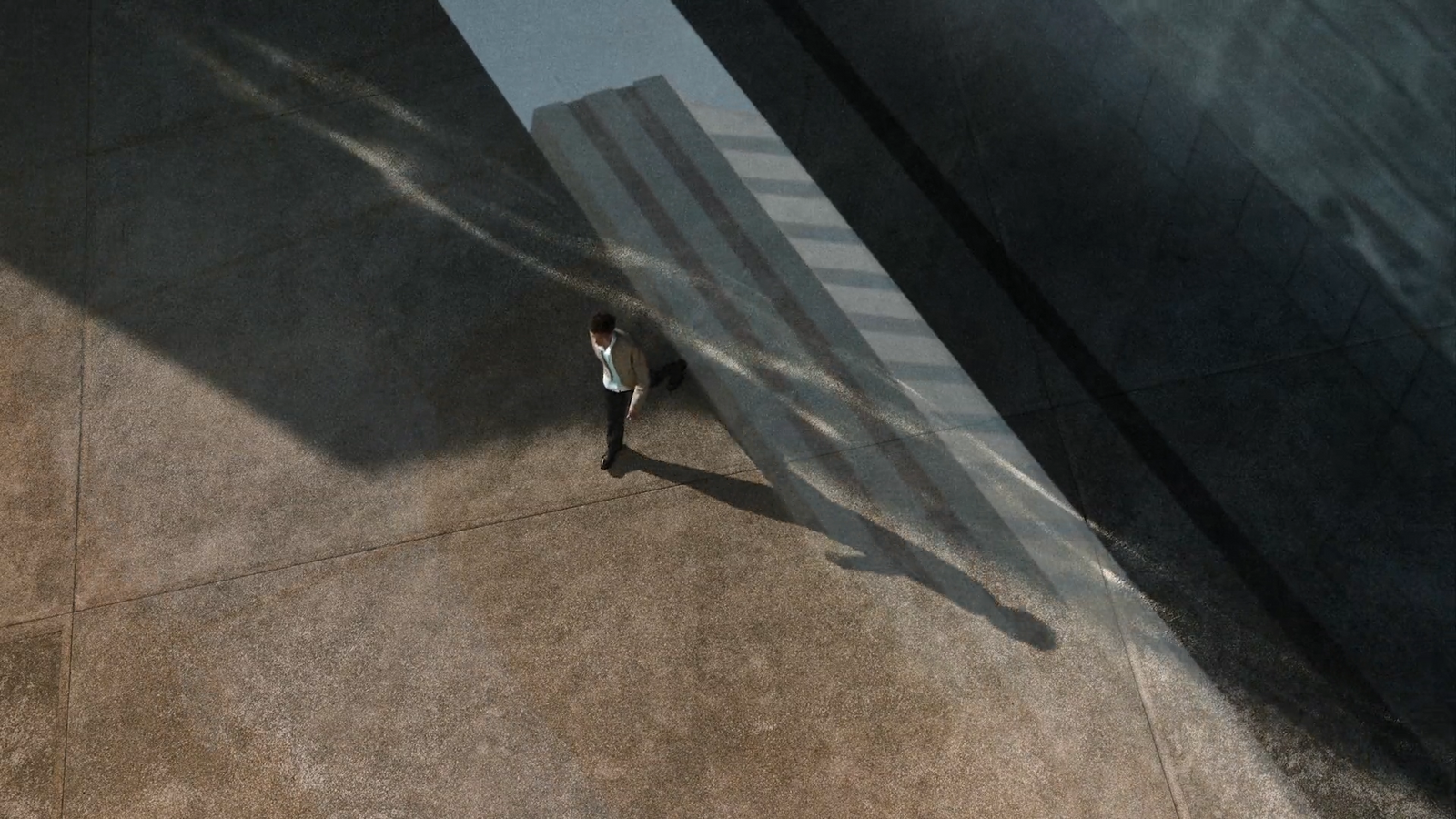 a man walking down a street next to a tall building