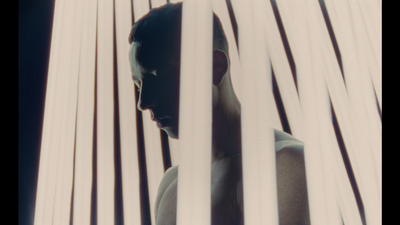 a man standing behind bars in a room