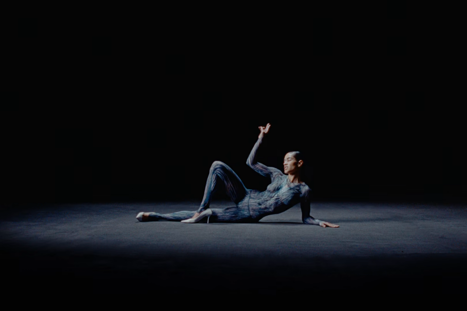 a man laying on the ground in the dark