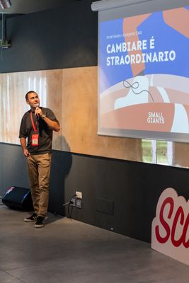 a man standing in front of a projector screen