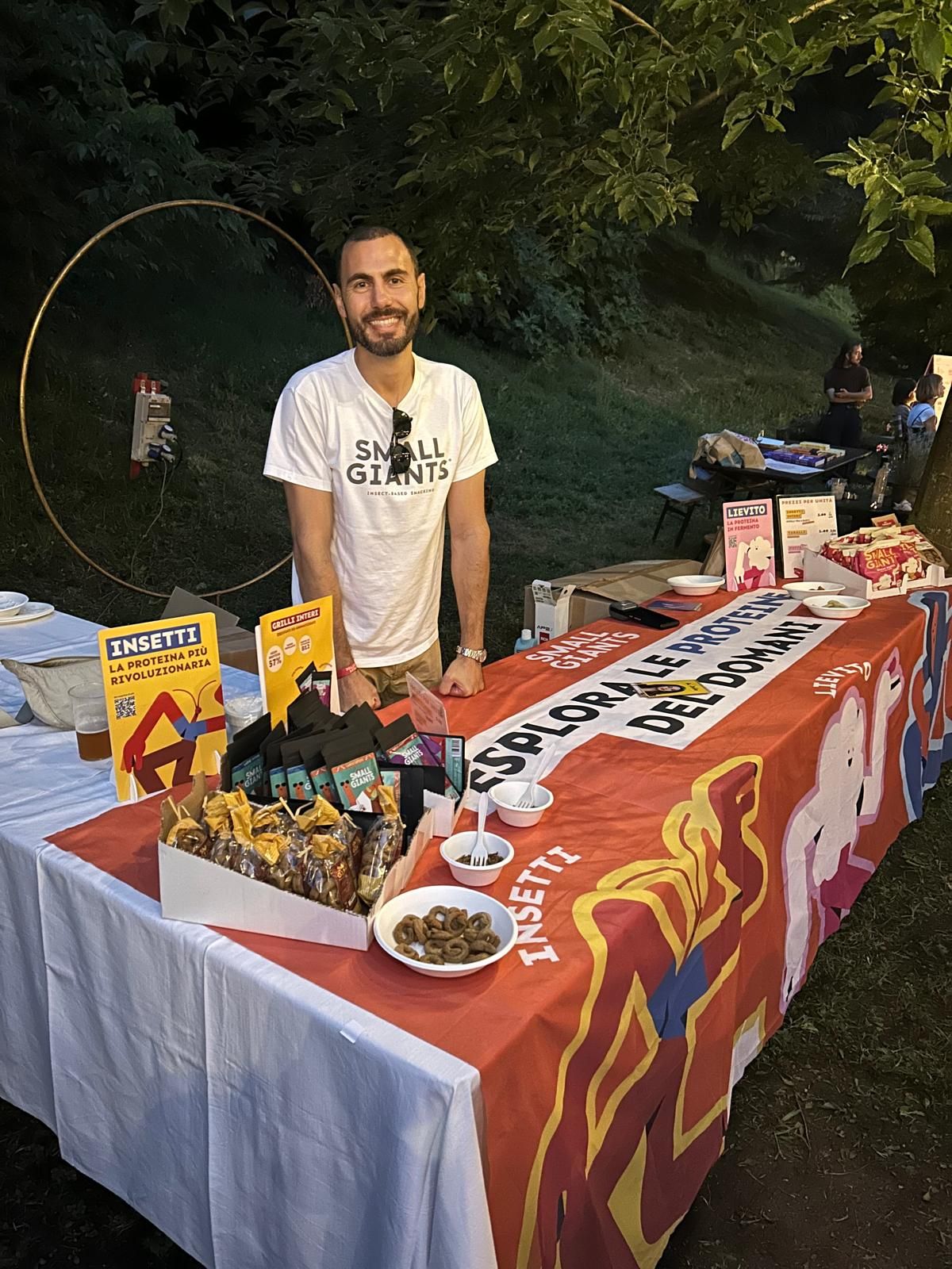 a man standing next to a table with food on it