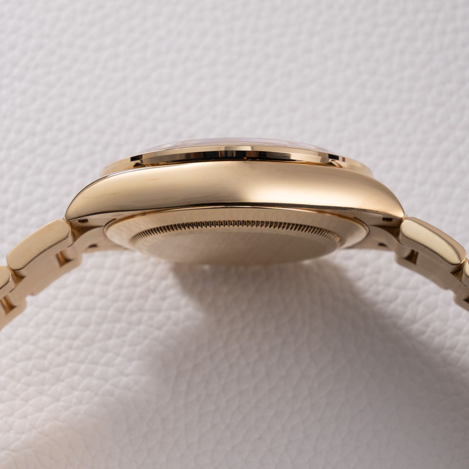 a close up of a watch on a white surface