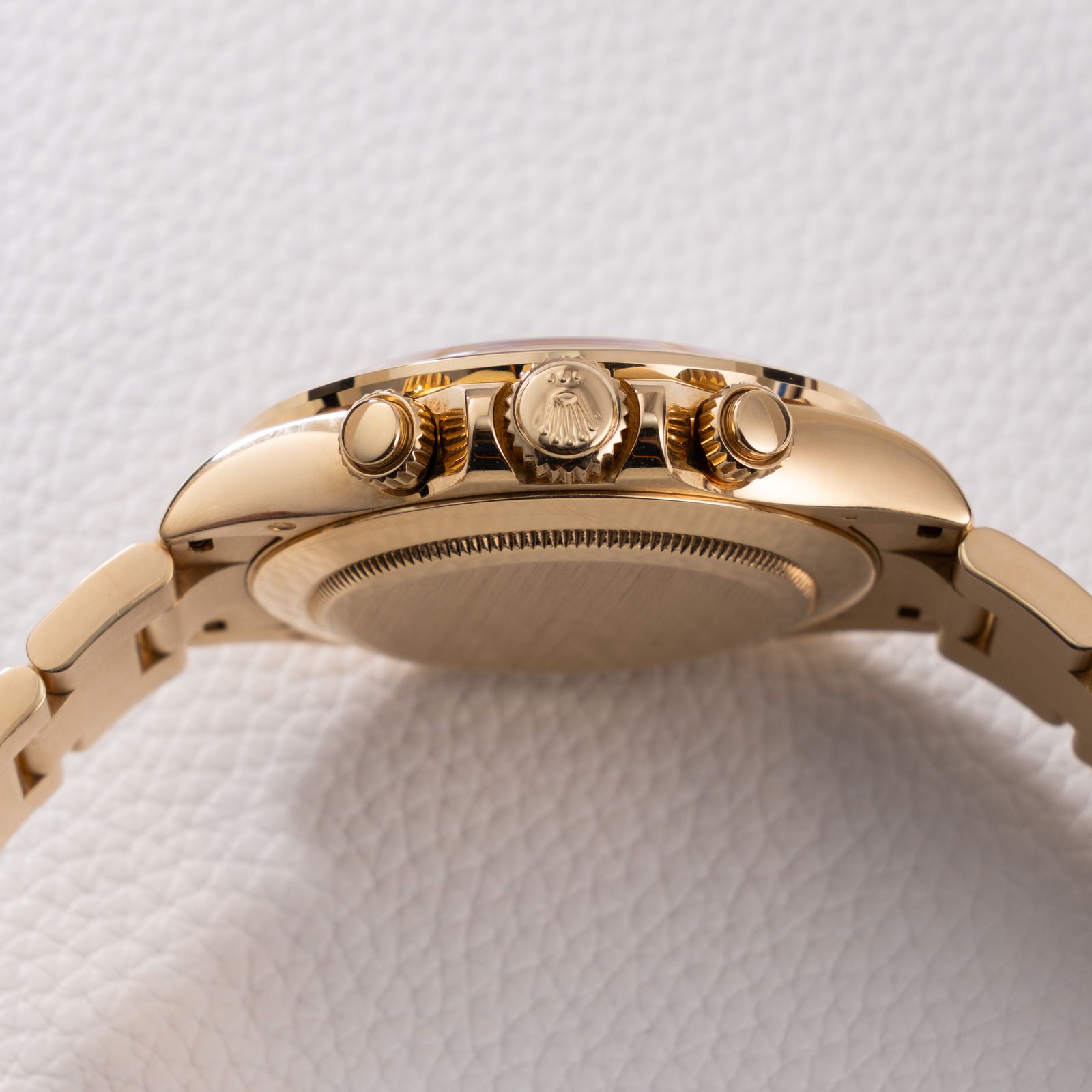 a close up of a watch on a white surface