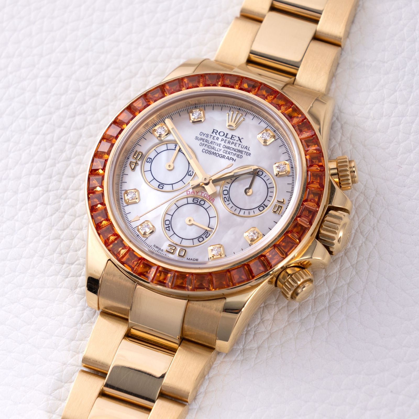 a gold rolex watch with a white background