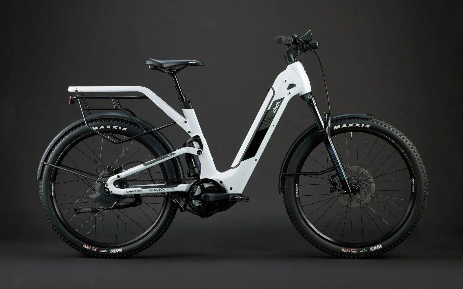 a white and black bike on a black background