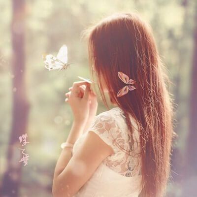 a woman standing in a forest with a butterfly in her hair