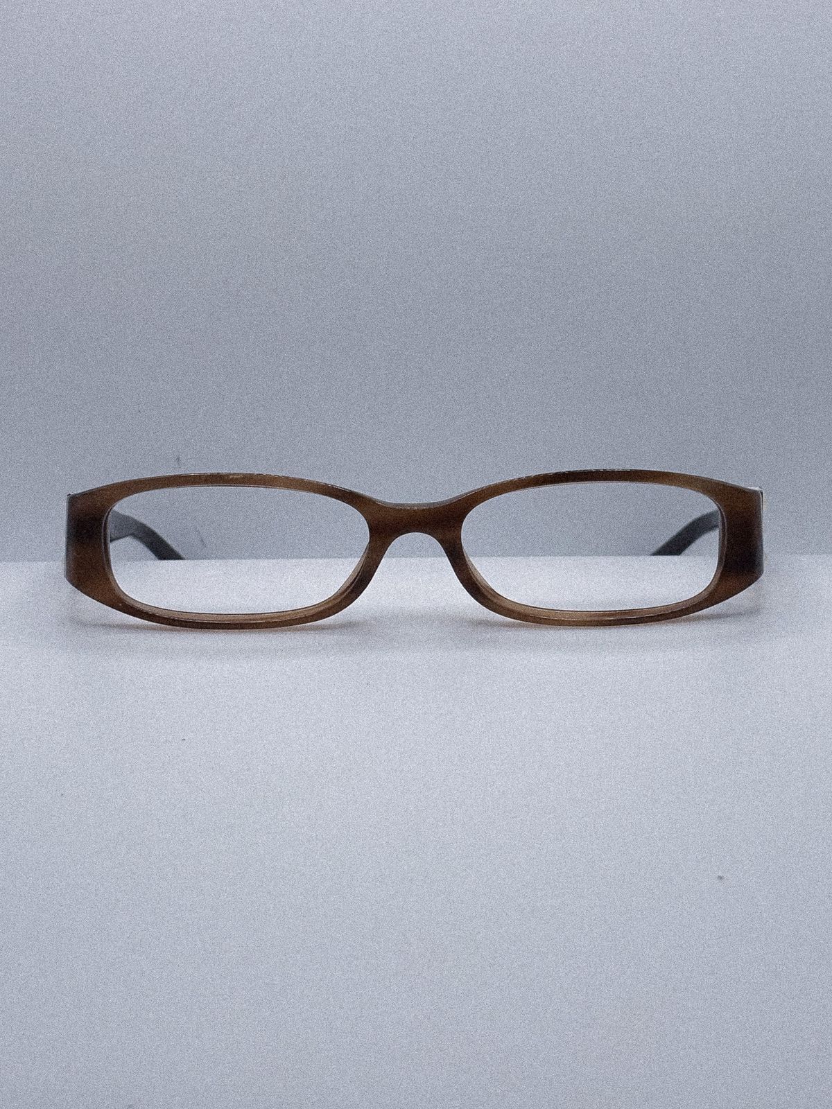 a pair of glasses sitting on top of a table
