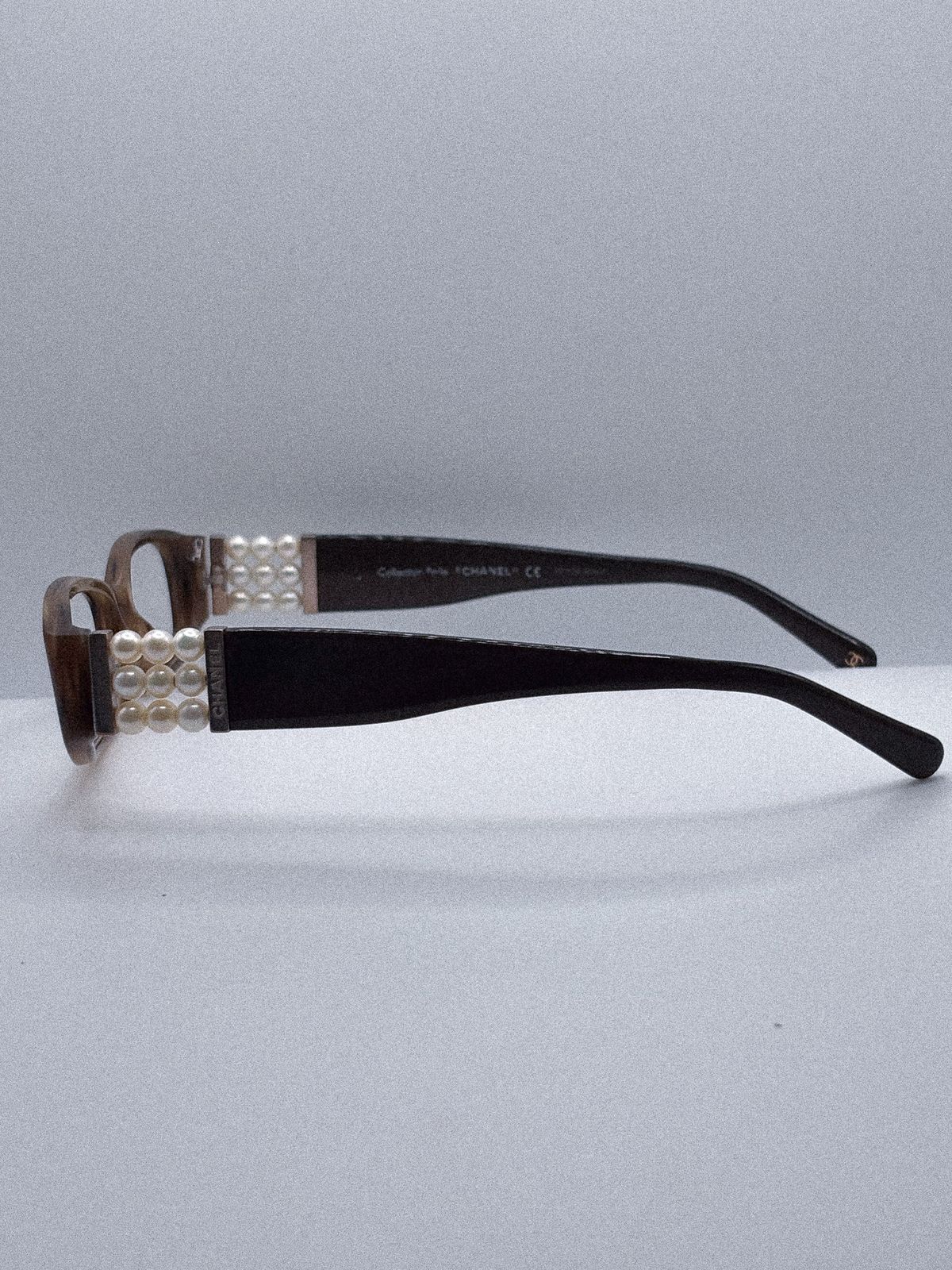 a pair of black and white eyeglasses sitting on top of a table