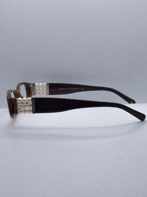 a pair of black and white eyeglasses sitting on top of a table