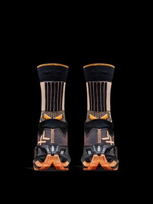 a pair of black and orange socks on a black background
