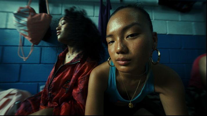 a woman sitting next to another woman in a room