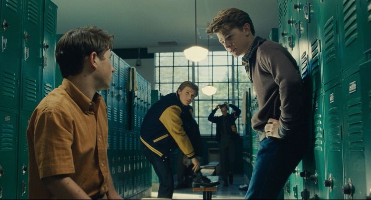 a group of young men standing in a locker room