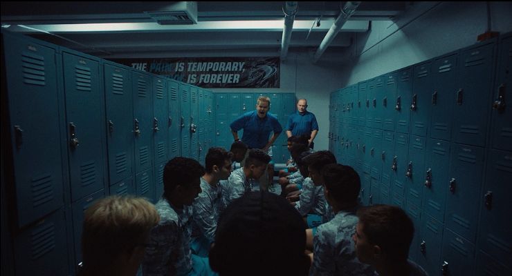 a group of people standing in front of lockers