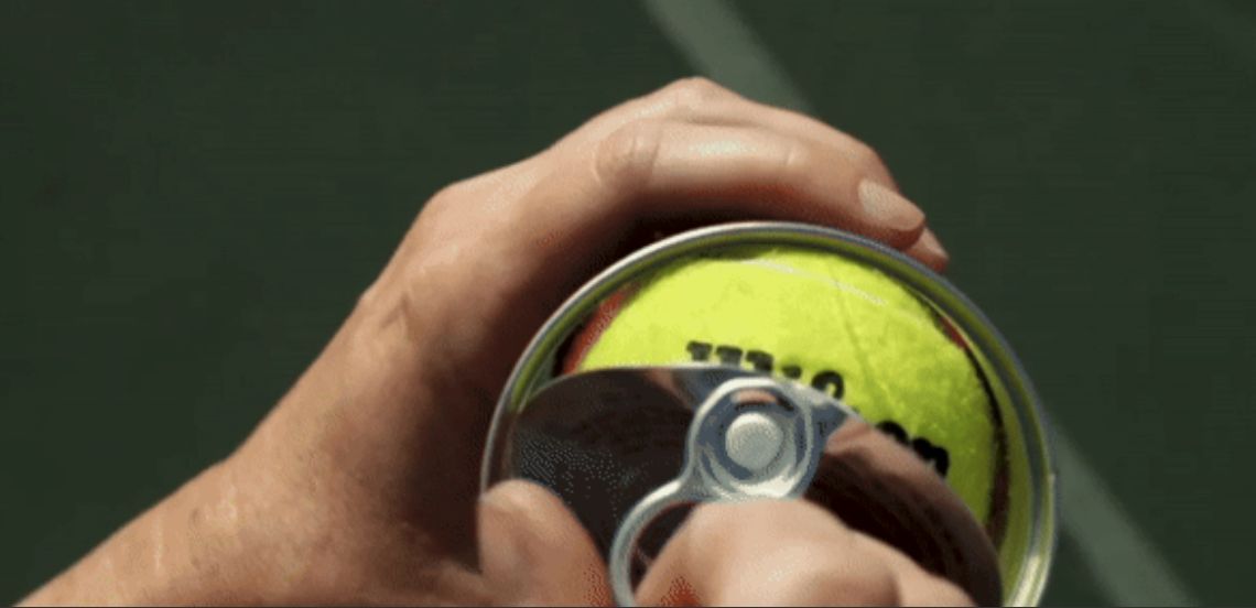 a person holding a tennis ball and a tennis racket